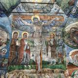 Kolorowe malowidło na ścianie przedstawiające ukrzyżowanie Chrystusa.