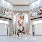 Monumentalne jasne wnętrze sanktuarium świętego Jana Pawła, na ścianach kolorowe malowidła.